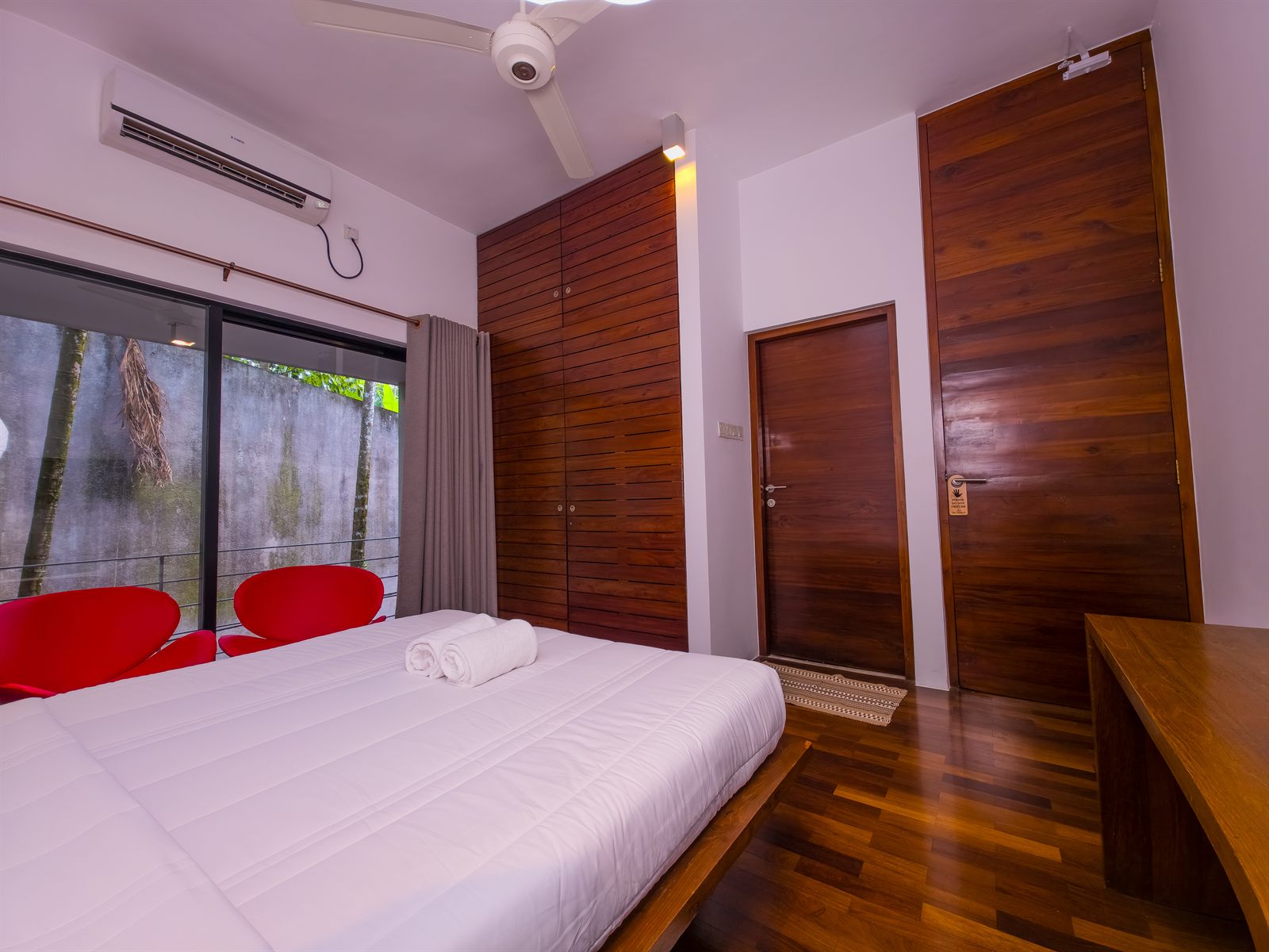 Deluxe Room with wooden wardrobe and balcony chairs