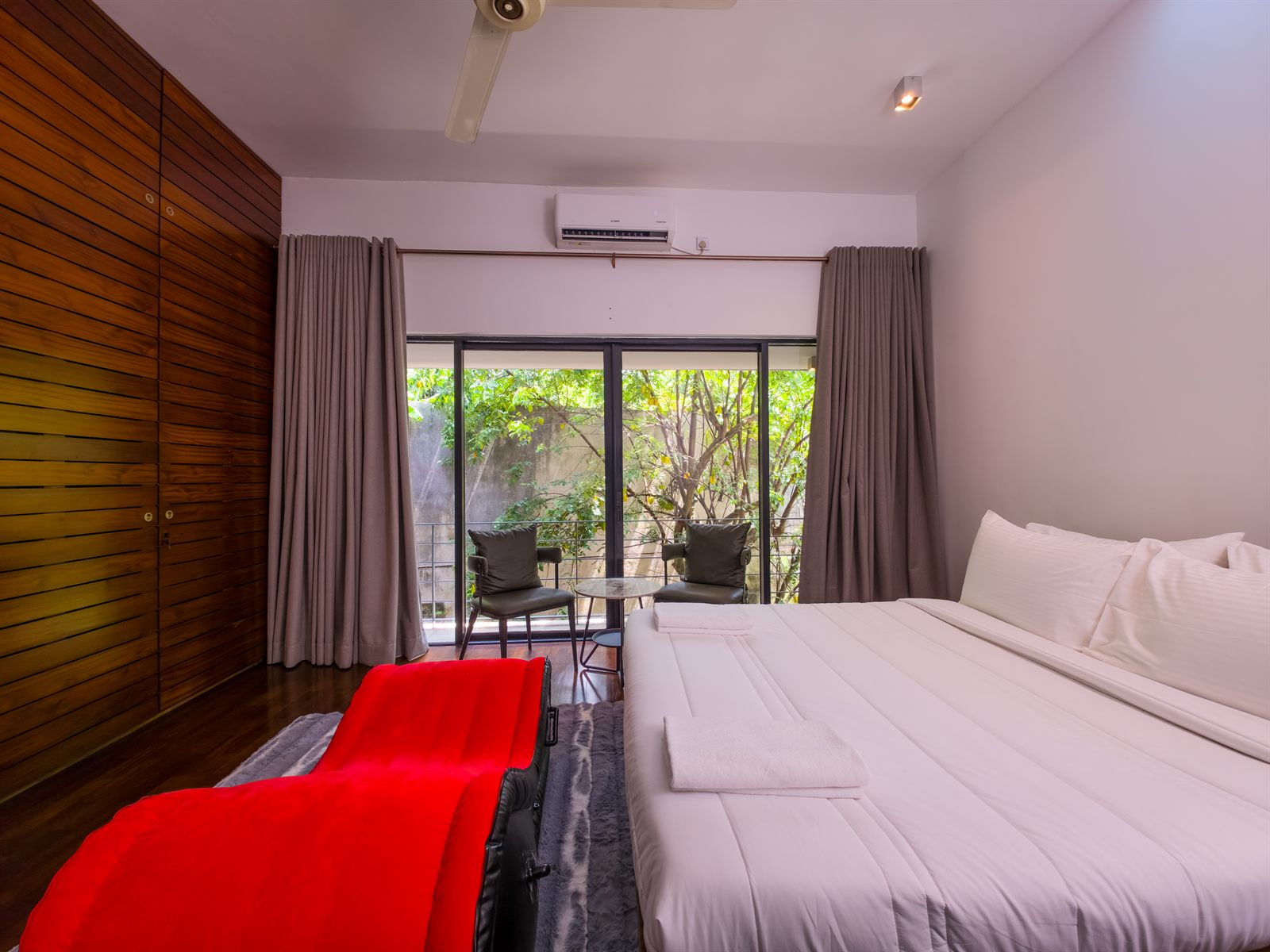 Superior Room bed facing garden balcony seating